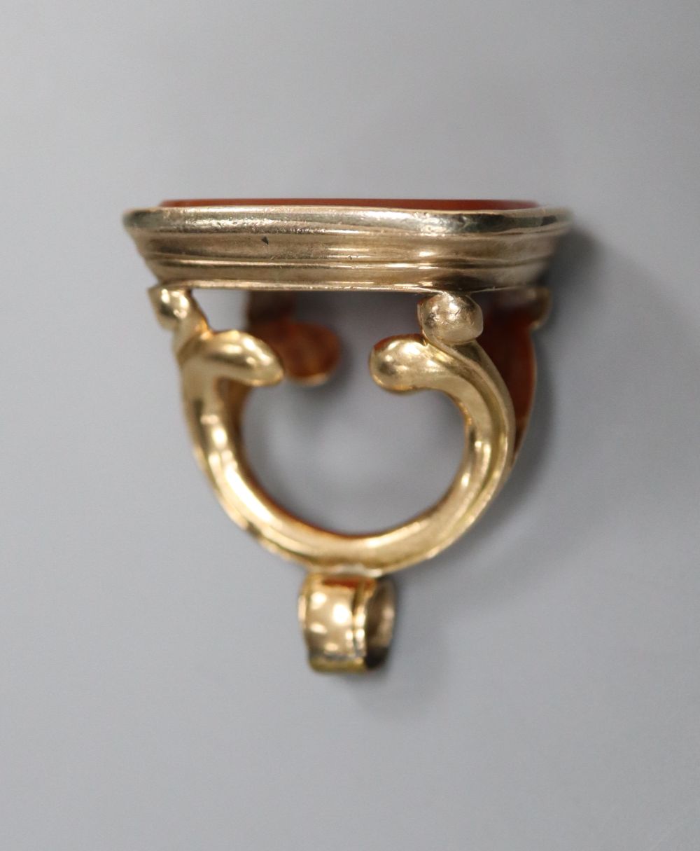 A 19th century gold (tests as 14ct) fob seal with intaglio-cut carnelian matrix, 30mm, gross 15.9 grams.